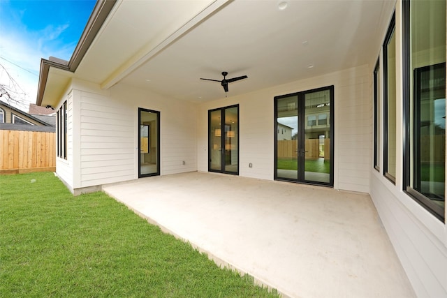 exterior space featuring a lawn, a patio, ceiling fan, and fence