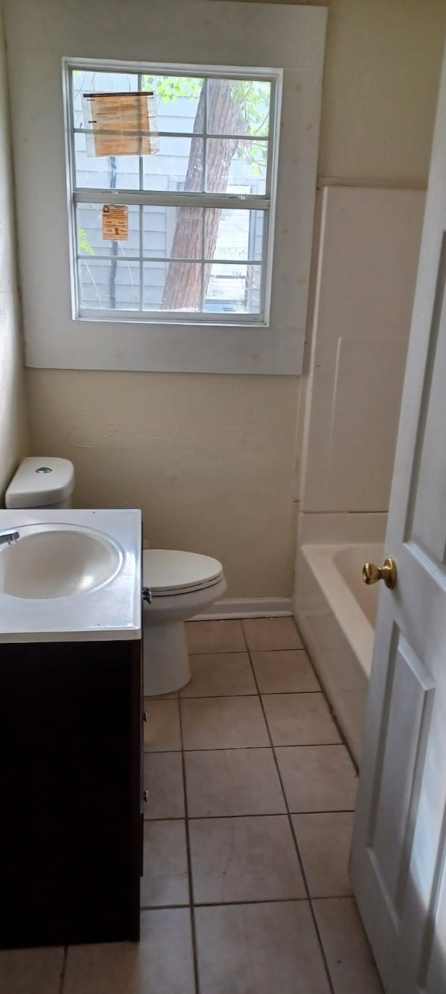 bathroom with tile patterned flooring, vanity, and toilet