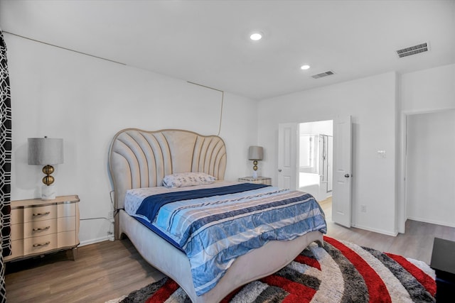 bedroom with hardwood / wood-style floors