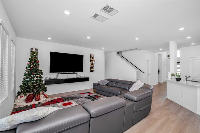 living room featuring light hardwood / wood-style floors and sink