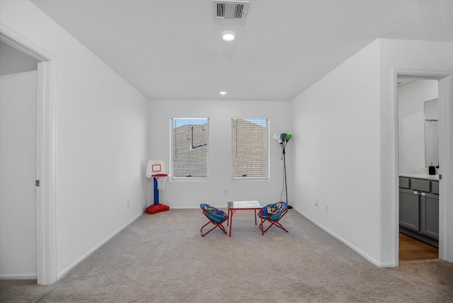 recreation room featuring light colored carpet