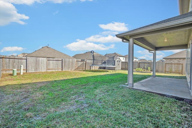 view of yard featuring a patio and a trampoline