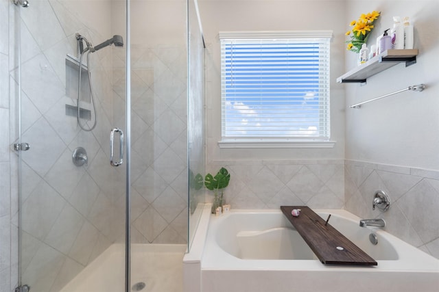 bathroom with shower with separate bathtub and a wealth of natural light