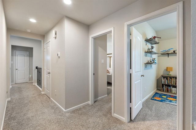 hallway with light colored carpet