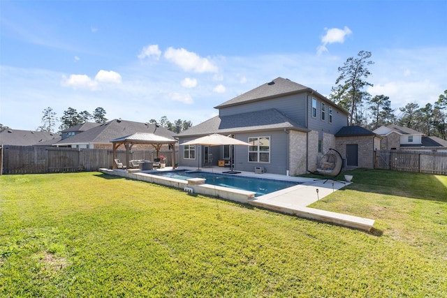 back of property with a gazebo, a yard, a fenced in pool, and a patio