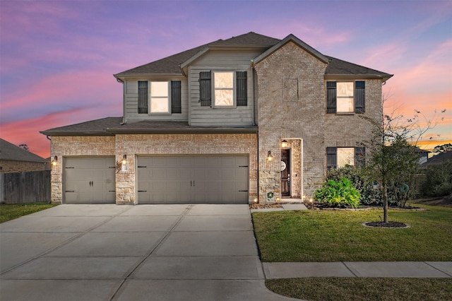 view of front of home with a yard and a garage