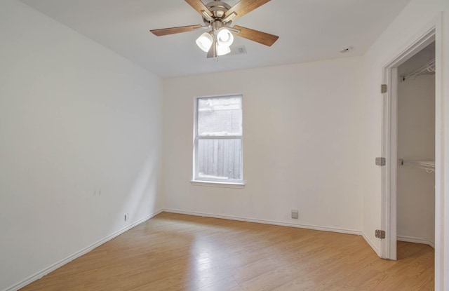 empty room featuring ceiling fan and light wood-type flooring