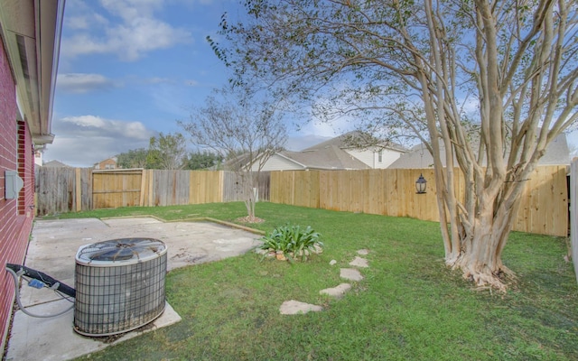 view of yard featuring central AC unit and a patio area