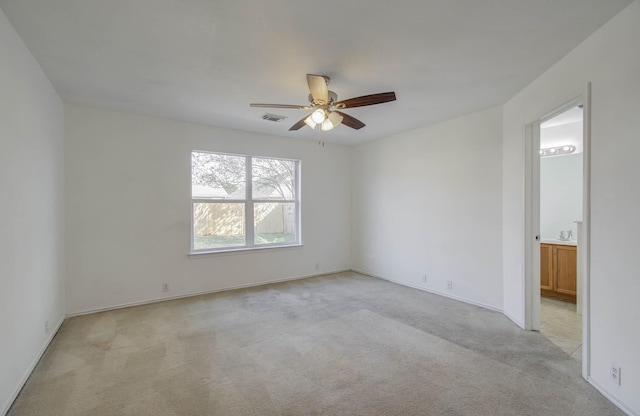 carpeted empty room with ceiling fan and sink