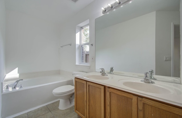 bathroom featuring tile patterned floors, vanity, toilet, and a tub to relax in