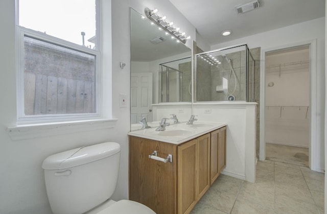 bathroom with plenty of natural light, toilet, an enclosed shower, and vanity