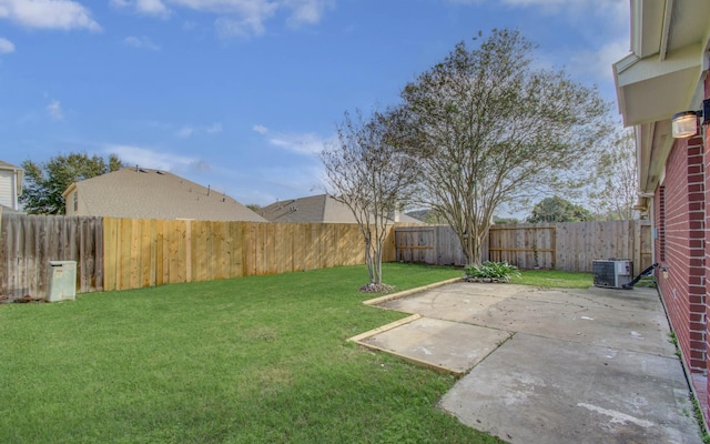 view of yard featuring central AC and a patio