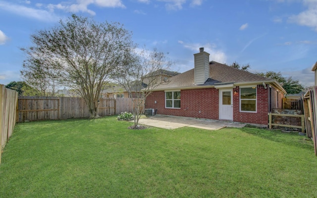 back of property with a patio, central air condition unit, and a lawn