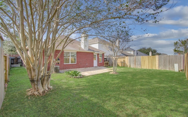 view of yard featuring central AC unit and a patio area