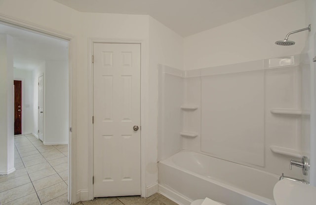 bathroom with bathtub / shower combination and tile patterned flooring