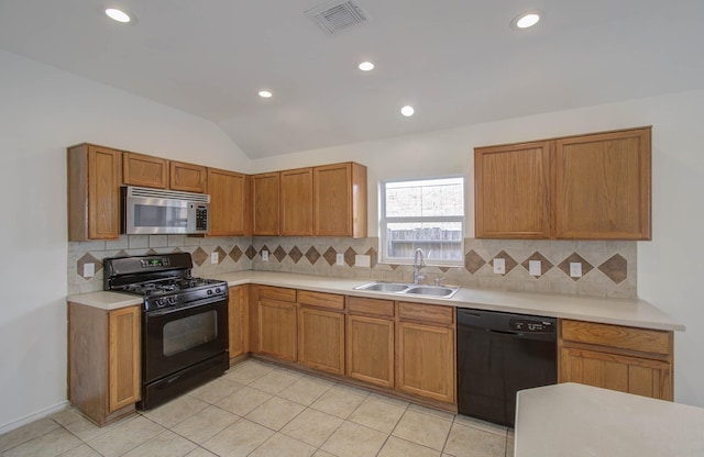 kitchen with sink, tasteful backsplash, lofted ceiling, and black appliances