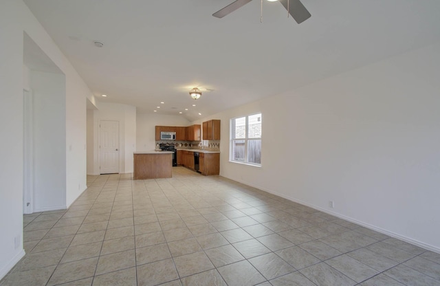 kitchen with lofted ceiling, backsplash, ceiling fan, light tile patterned floors, and black range with electric cooktop