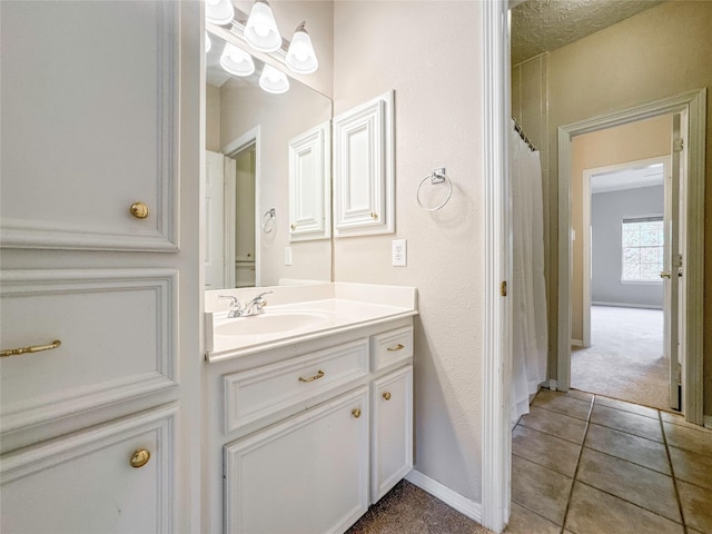 bathroom featuring tile patterned flooring and vanity