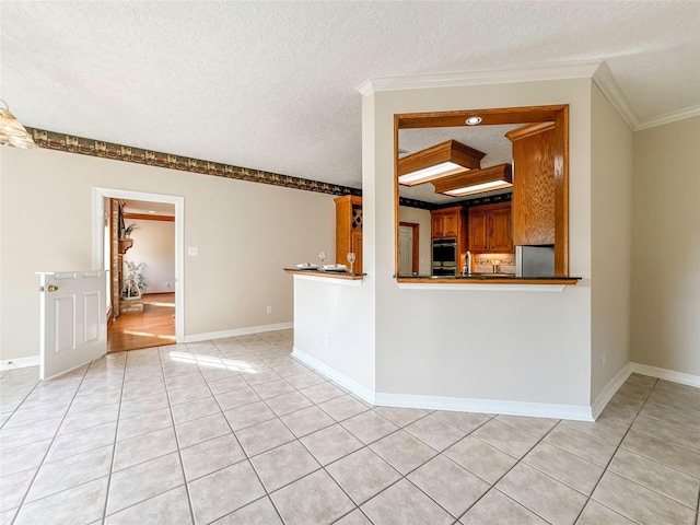 unfurnished living room with a textured ceiling, crown molding, and light tile patterned flooring