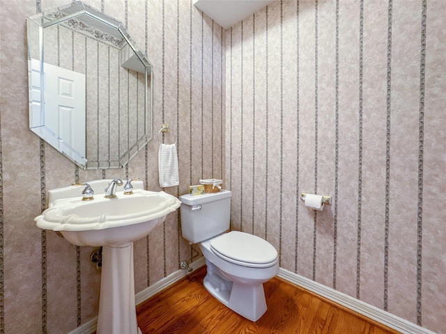 bathroom featuring hardwood / wood-style floors and toilet