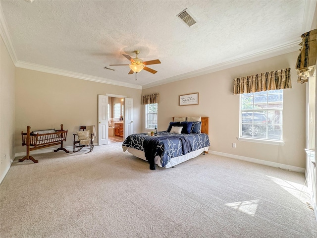 carpeted bedroom featuring ensuite bath, ornamental molding, a textured ceiling, ceiling fan, and multiple windows