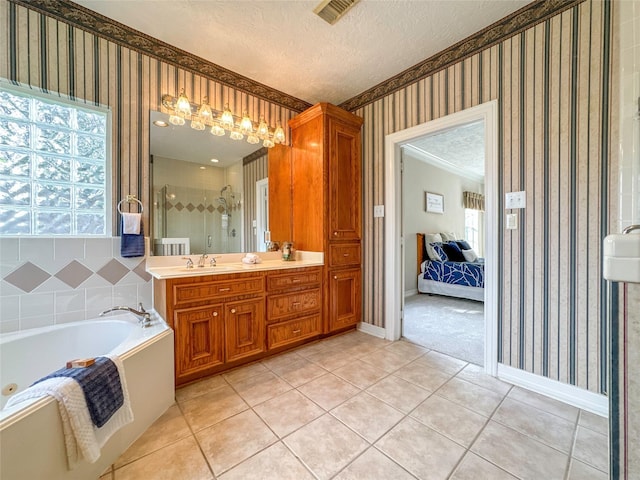 bathroom with vanity, a textured ceiling, independent shower and bath, and tile patterned flooring