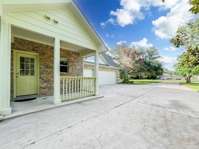 view of home's exterior featuring a garage and covered porch