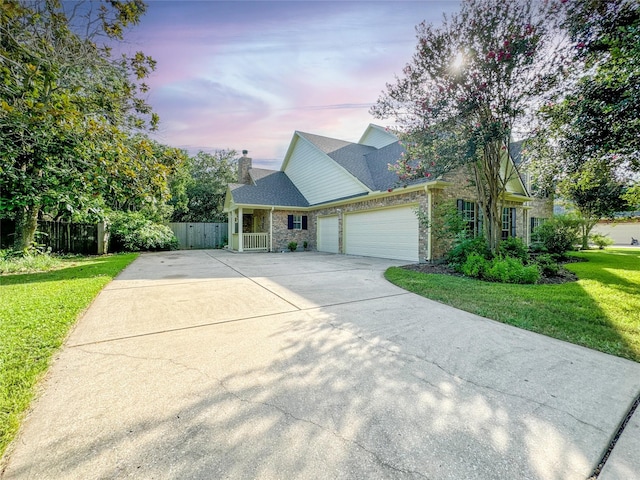 view of front of property featuring a yard and a garage