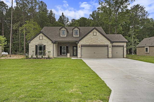 french country style house with a front lawn and a garage