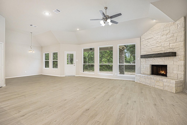 unfurnished living room featuring ceiling fan, vaulted ceiling, a fireplace, and light hardwood / wood-style flooring