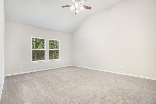 carpeted empty room featuring ceiling fan and vaulted ceiling