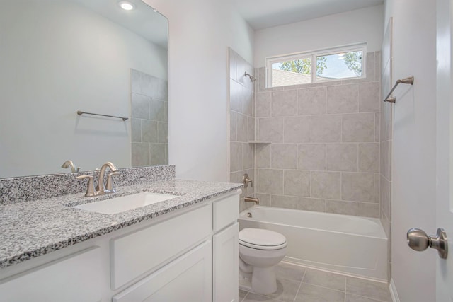 full bathroom featuring tile patterned floors, vanity, toilet, and tiled shower / bath