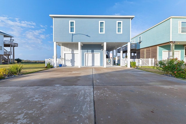 rear view of house featuring a carport and a garage