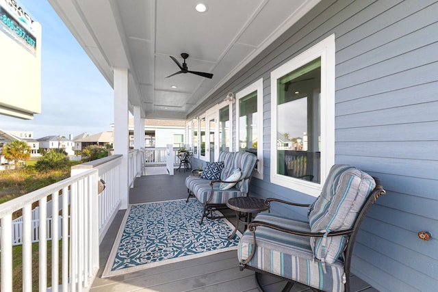 balcony featuring ceiling fan and a porch