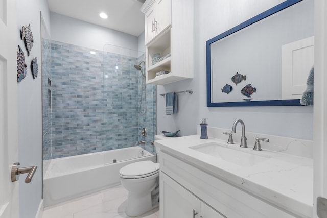 full bathroom featuring tiled shower / bath combo, toilet, and vanity