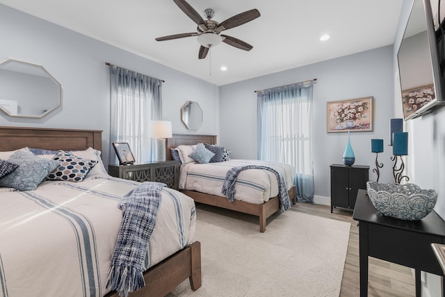 bedroom with ceiling fan and light hardwood / wood-style floors