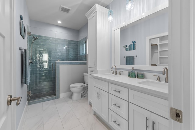 bathroom featuring vanity, toilet, and an enclosed shower