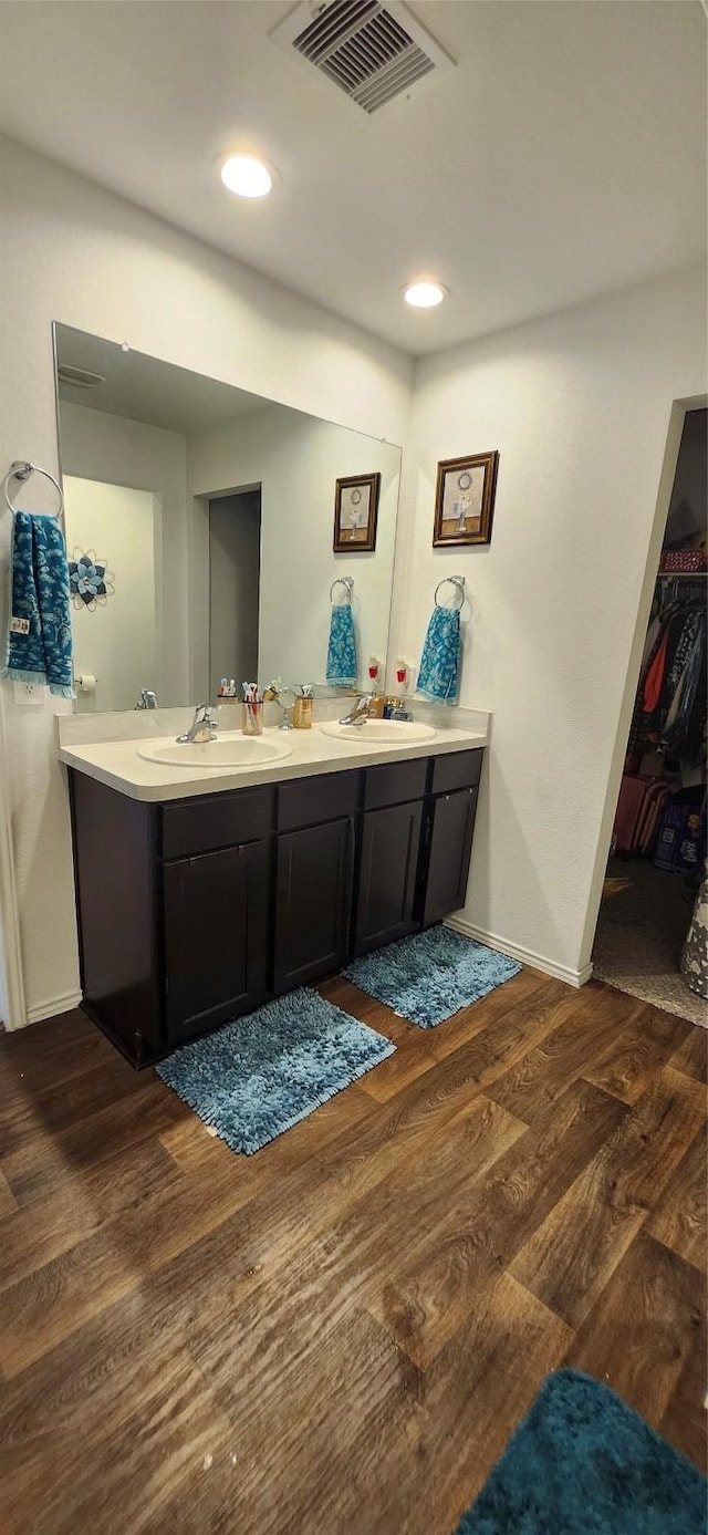 bathroom with hardwood / wood-style floors and vanity