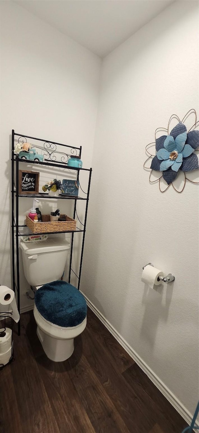 bathroom with hardwood / wood-style flooring and toilet