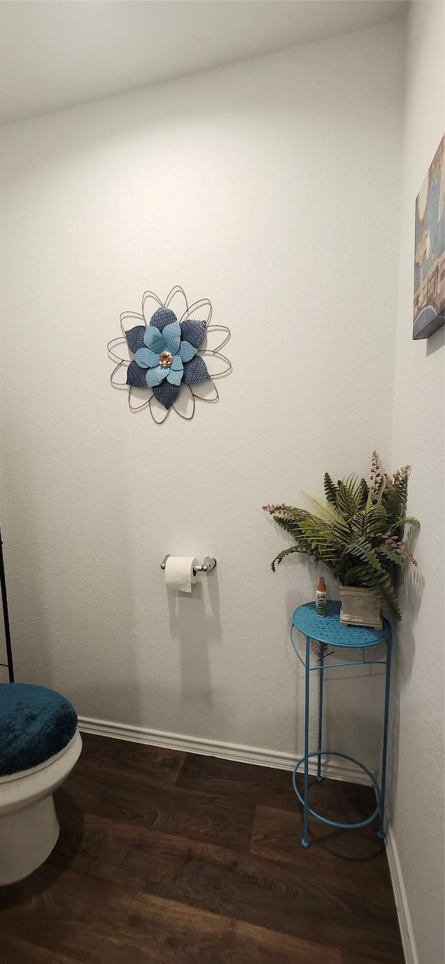 bathroom featuring hardwood / wood-style floors and toilet