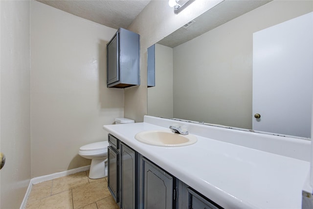 bathroom with tile patterned floors, vanity, toilet, and a textured ceiling