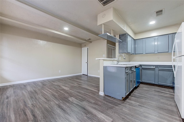 kitchen with sink, dark wood-type flooring, a textured ceiling, and white refrigerator