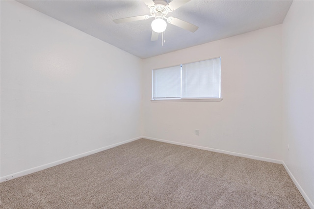 spare room featuring carpet and ceiling fan