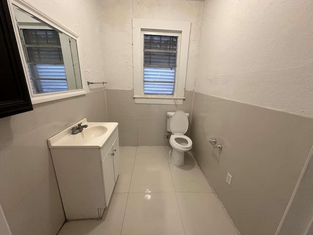 bathroom featuring tile patterned flooring, vanity, and toilet