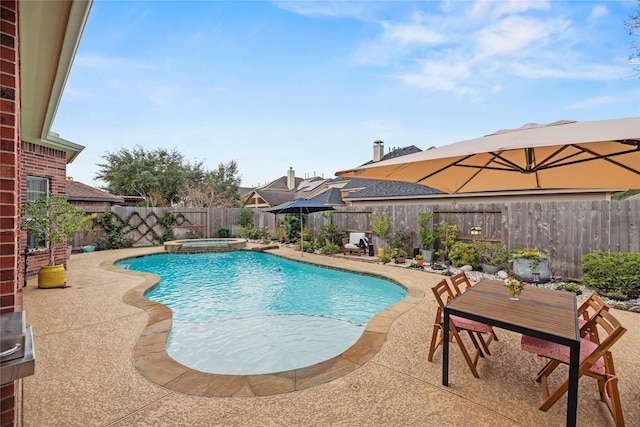 view of swimming pool featuring an in ground hot tub and a patio area