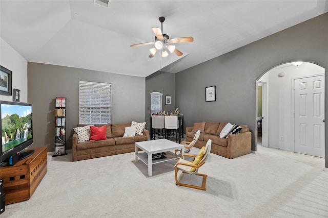 living room featuring light carpet, vaulted ceiling, and ceiling fan