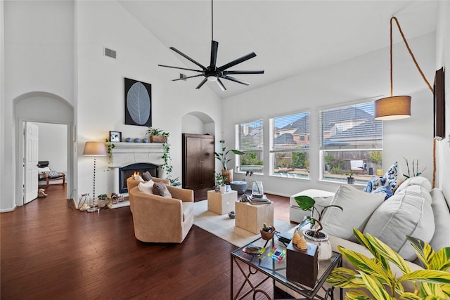 living room featuring ceiling fan, dark hardwood / wood-style flooring, and high vaulted ceiling