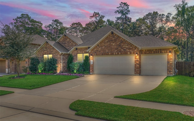 view of front of house featuring a garage and a lawn