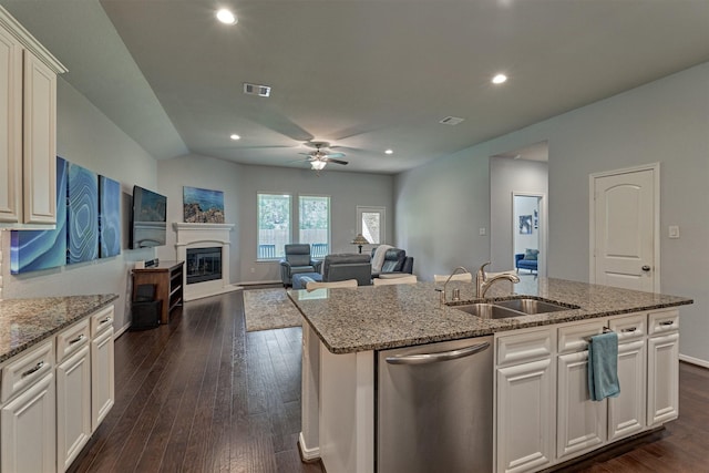 kitchen featuring white cabinets, sink, an island with sink, and stainless steel dishwasher