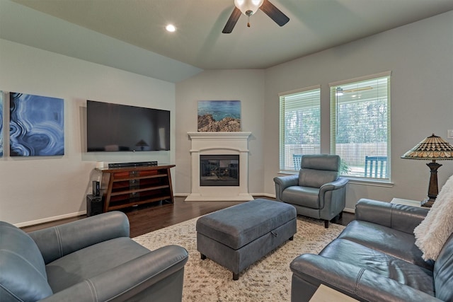 living room with hardwood / wood-style flooring, ceiling fan, and lofted ceiling